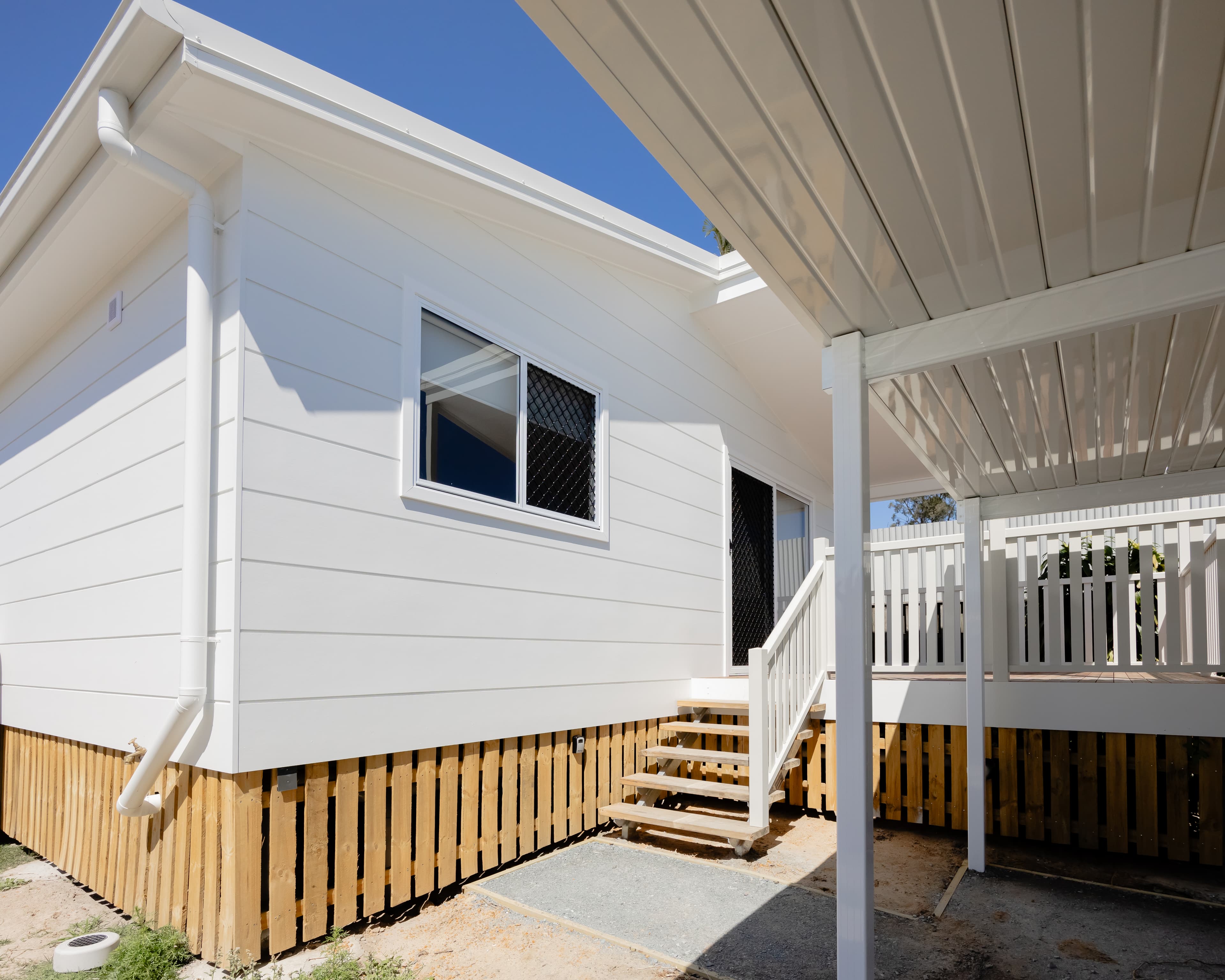 A finished home with a deck and stairs